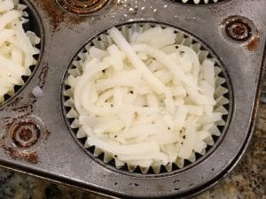 Shredded potatoes placed in foil baking cup