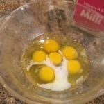 Eggs and milk in mixing bowl