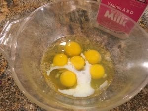 Eggs and milk in mixing bowl