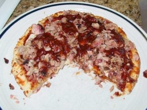 Barbecue pizza with one slice removed