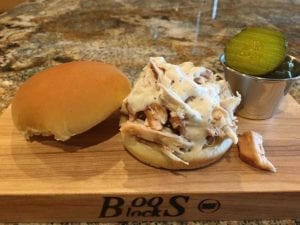 Alabama-style pulled chicken sandwich drizzled with white sauce