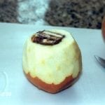 Apple topped, peeled and stuffed with candy