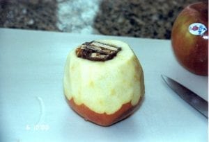 Apple topped, peeled and stuffed with candy