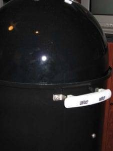 Close-up of Weber handles on middle cooking section