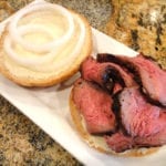 Baltimore pit beef with horseradish sauce and raw white onion on a roll