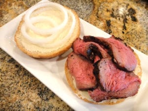 Baltimore pit beef with horseradish sauce and raw white onion on a roll