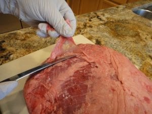 Trimming fat and silver skin from roast
