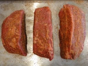 Roast cut into three chunks and seasoned with rub