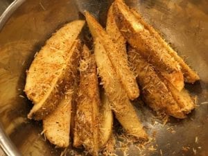 Wedges coated in olive oil, parmesan cheese and barbecue rub