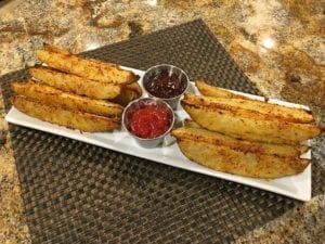 Parmesan barbecue potato wedges arranged on serving platter