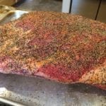 Surface of short ribs sprinkled with coarse black pepper