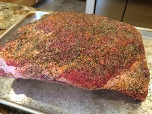 Surface of short ribs sprinkled with coarse black pepper
