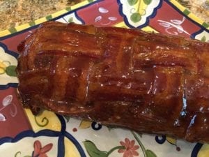 Breakfast bacon weave fatty on serving platter brushed with barbecue sauce