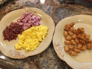 Fatty fillings including scrambled eggs, bacon, ham, and mini tater tots