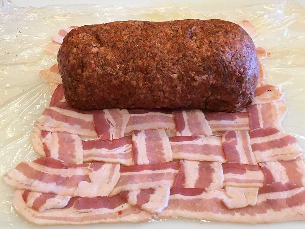 Ready to wrap bacon weave around rubbed sausage log