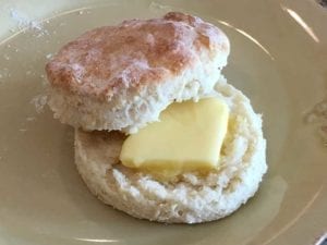 Close-up of a sour cream biscuit with butter
