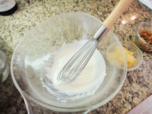 Whisking the dressing until smooth