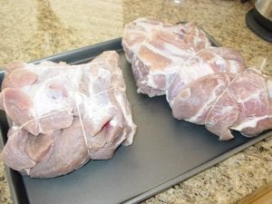 Pork butts tied after soaking, rinsing, and drying