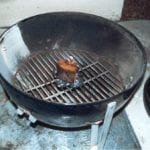 Four partially lit coals with smoke wood on top