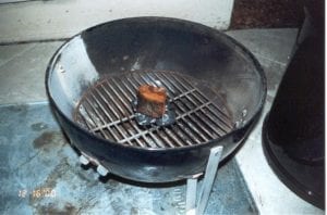 Four partially lit coals with smoke wood on top