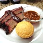 Sliced brisket with sauce, beans & corn muffin