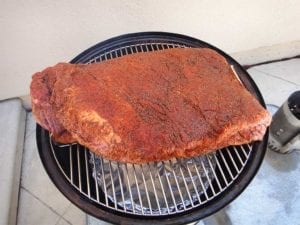 14+ pound brisket shoe-horned between top grate handles