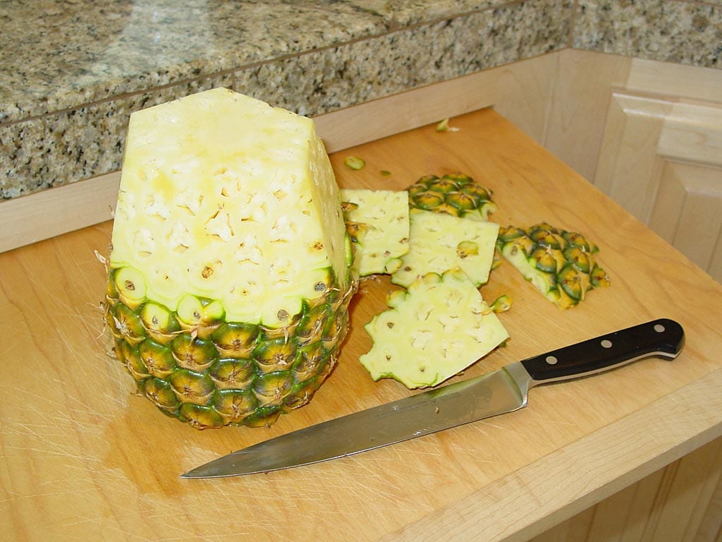 Cutting the shell from a hybrid pineapple