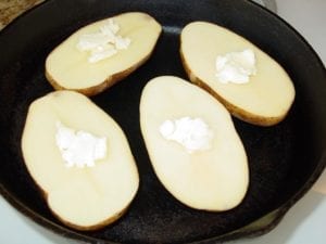 Raw potato halves with butter