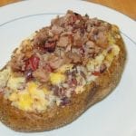 Twice-baked potato topped with butter, cheese, and more brisket