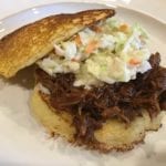 Pulled pork with coleslaw on cornmeal hoecakes