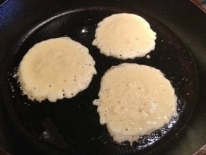 Cooking three hoecakes on first side
