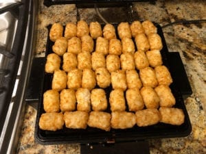 Counting out tater tots on cold waffle iron