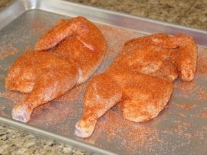 Chicken halves with rub applied