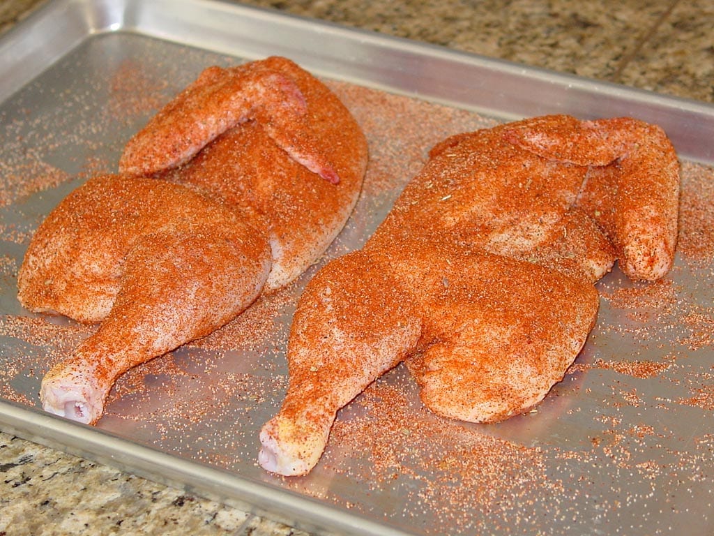 Chicken halves with rub applied