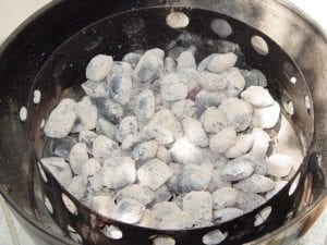 Hot coals spread in charcoal chamber