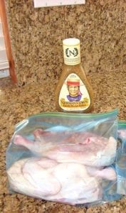 Split chicken halves and Newman's Own Family Recipe Italian Dressing