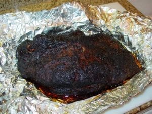 Accumulated juices after brisket has rested in foil