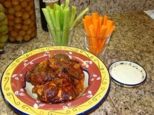 Buffalo wings served with celery sticks, carrot sticks, and blue cheese dressing