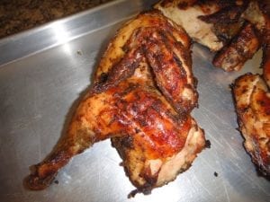 Close-up of chicken skin crisped over hot coals