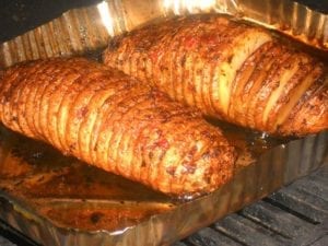 Hasselback potatoes roasting in a hot grill
