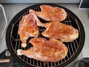 Chicken placed skin-side down on top cooking grate