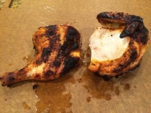 Half chicken separated into leg quarter and breast/wing