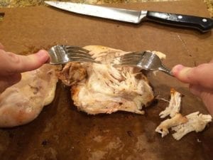 Shredding breast meat with two forks