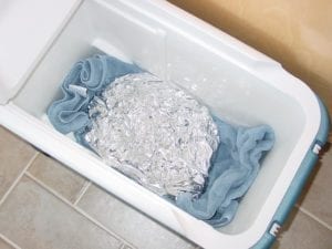 Foiled pastrami goes into an empty cooler to rest
