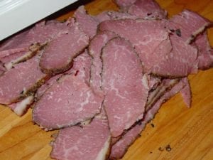 Slices of homemade pastrami smoked in the Weber Bullet
