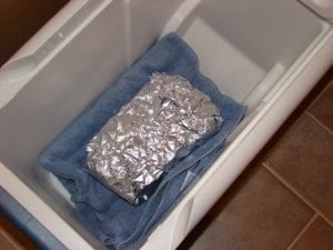 Quick pastrami resting in an empty cooler after cooking