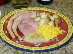 Spiral-sliced ham with potatoes, corn, and apple sauce