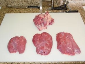 Three trimmed pieces of lamb with meaty scraps
