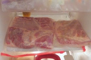Bagged pork belly pieces go into the refrigerator