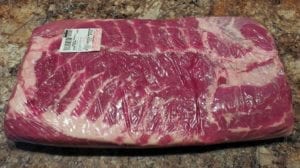 A whole pork belly in Cryovac packaging